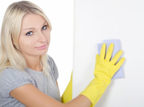 Cleaner using protective equipment during a cleaning service