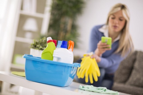 Cleaner treating a fabric armchair during upholstery cleaning