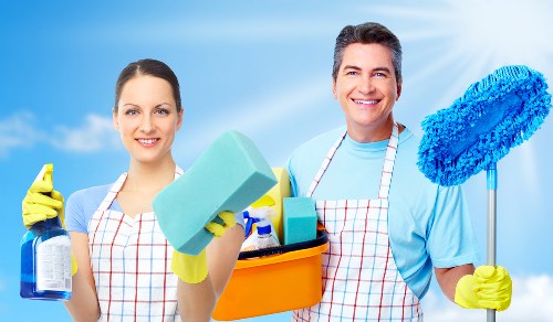Office cleaner maintaining desks and floors in Stjohnswood